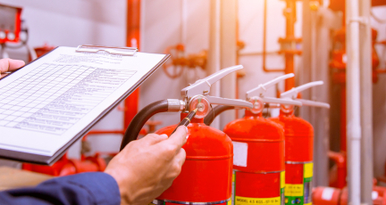 A man doing fire extinguisher inspection.