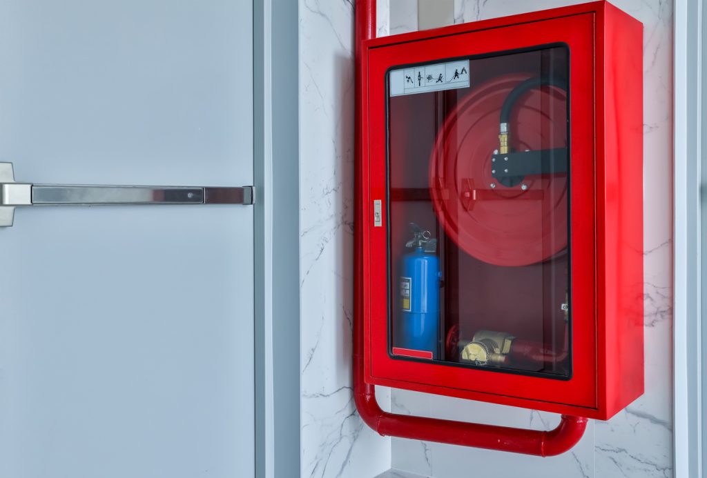 Hydrant with water hoses and fire extinguish equipment.